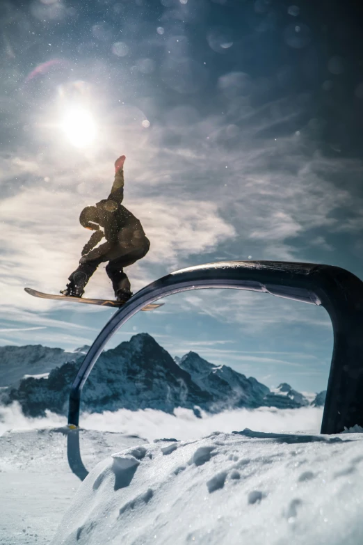 a man on a snowboard is jumping over the edge of a ramp