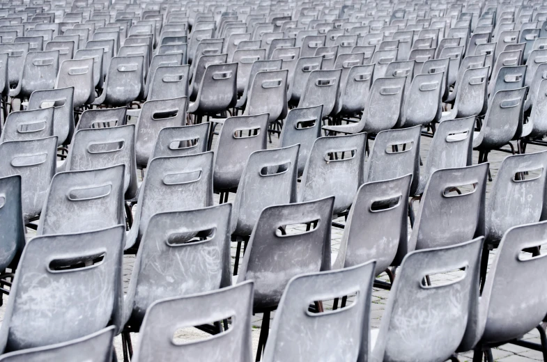 many chairs are shown side by side in an empty stadium