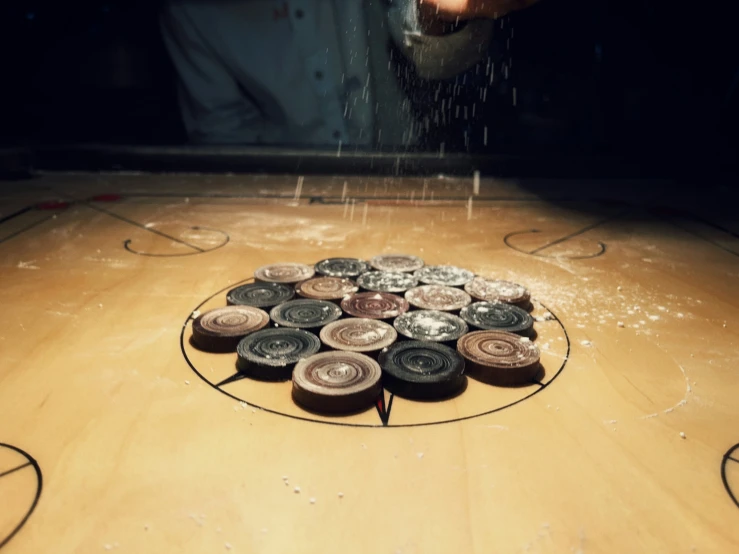 a wood table topped with a circle filled with magnets