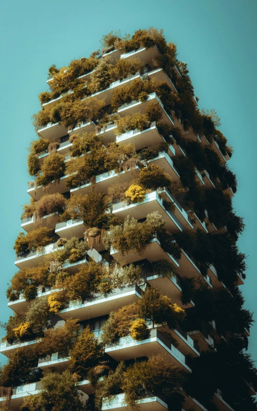 a high rise building with plants growing out the sides