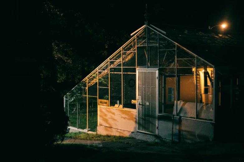 an outhouse with all its windows closed in the night