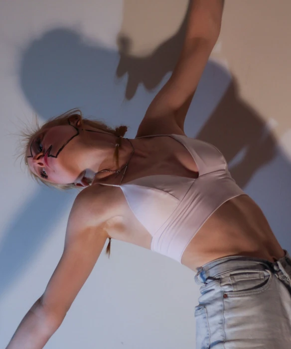 a young woman poses in a tank top