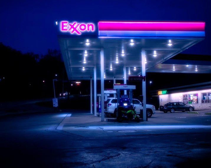 an exxon gas station lit up at night