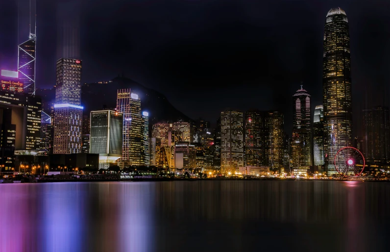 a city skyline with many lights reflecting in the water