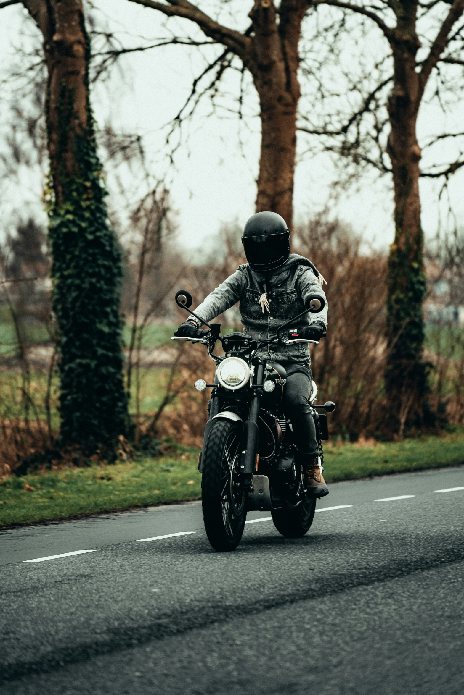 person riding a motorcylce along a country road