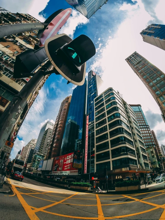 looking up at the street intersection from underneath a stoplight