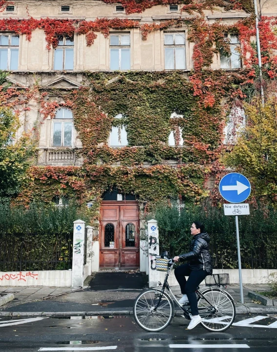 a person riding a bike down a street next to a building