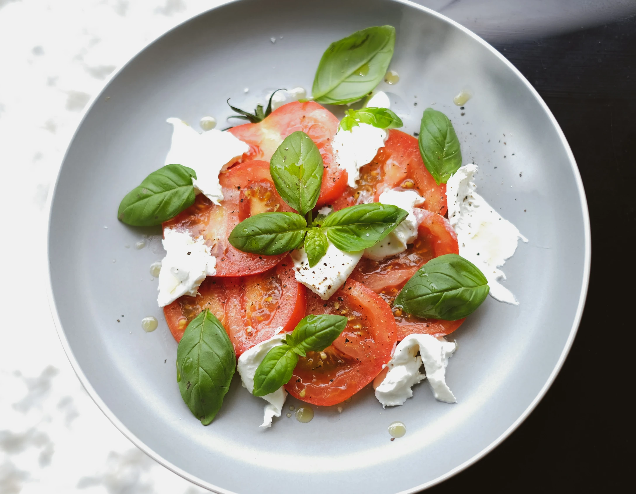 this is a plate that has cheese and tomatoes