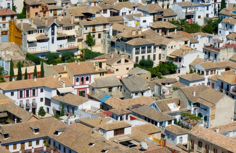 lots of houses in an area with roofs that have tiles on them