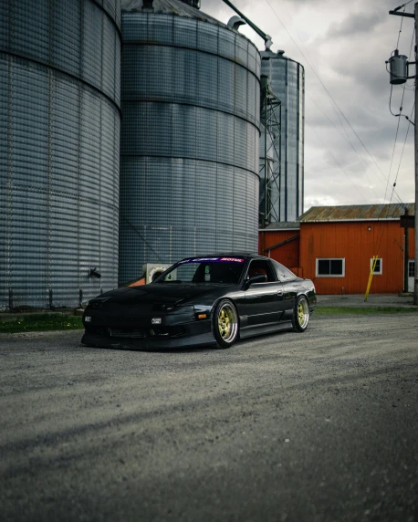 a car parked in front of a silo