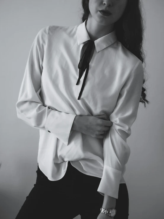 a woman in a shirt and tie poses for a black and white po