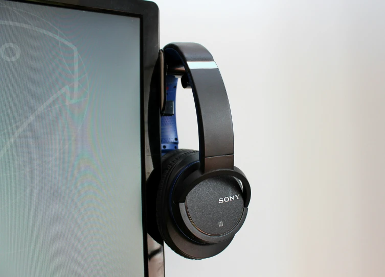 headphones are sitting on a monitor screen