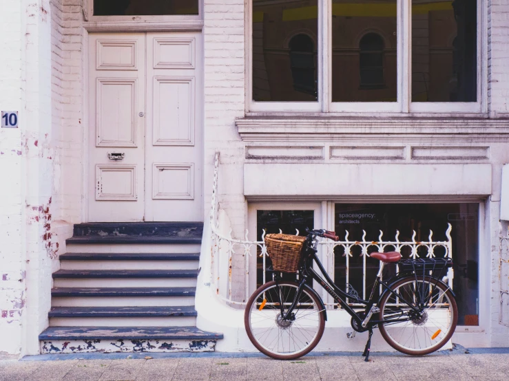 a bike is leaning up against a door