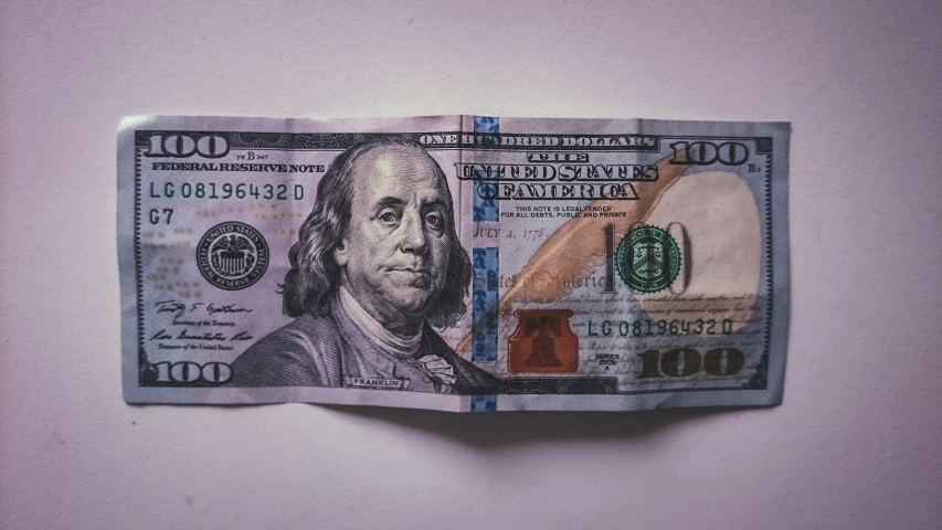 two twenty dollar bills with a drawing of george washington sitting on top