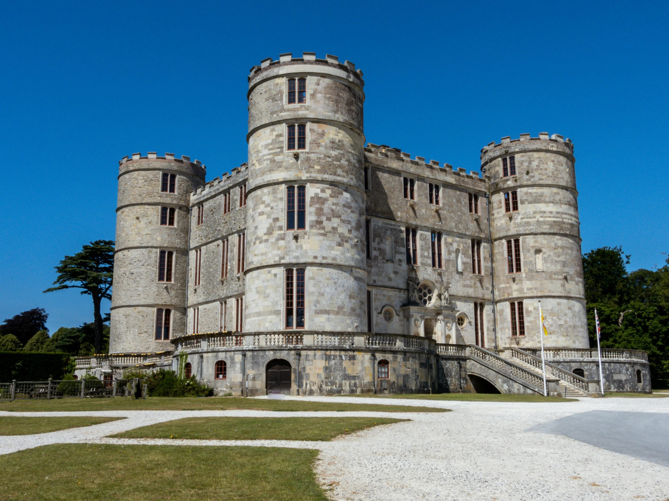 a tall castle with a staircase going into the front