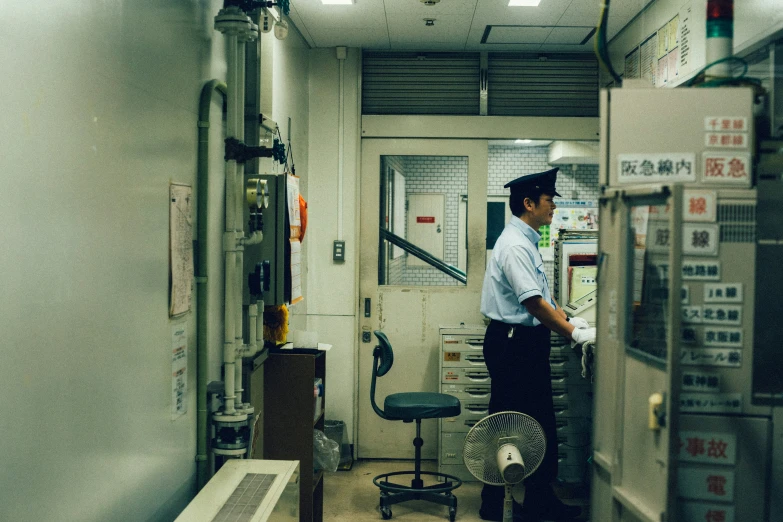 a man standing in an office with several things