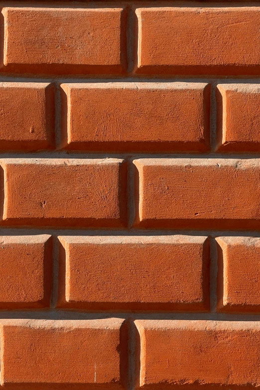 an orange brick wall textured with tan paint