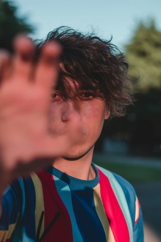 a closeup of a person making a face with their hand