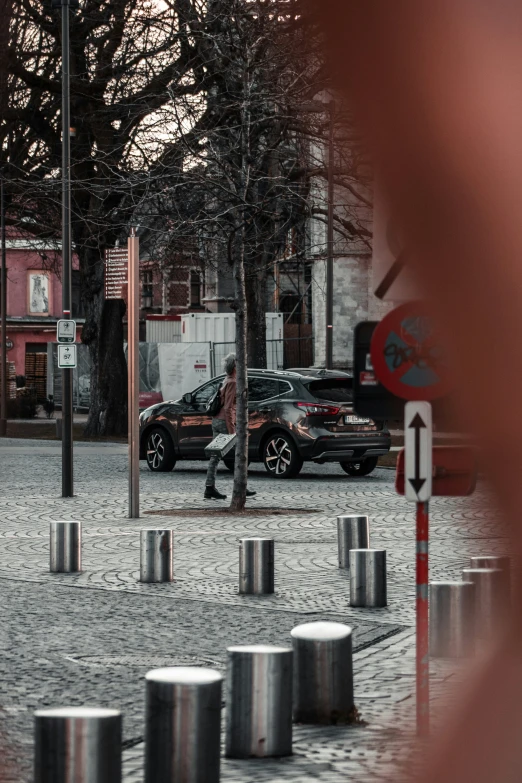 vehicles are seen in a traffic park with trees