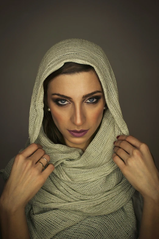 a young woman is wearing a hoody scarf