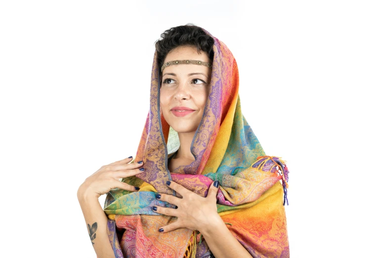 a woman in a rainbow colored shawl posing for a po