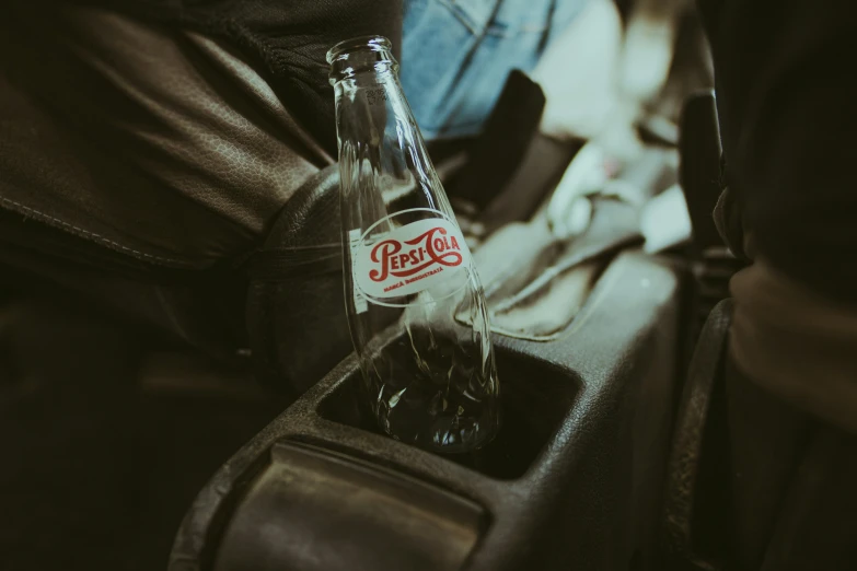 a close up of a bottle with a zippered pocket