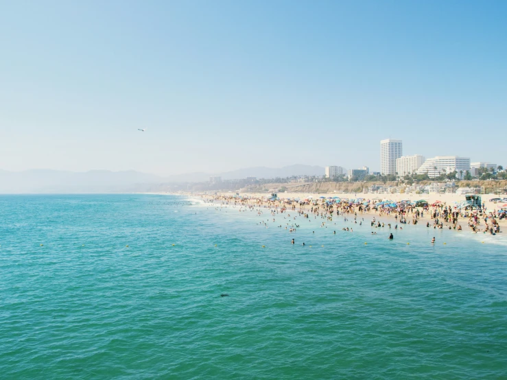 a crowd of people swimming in the ocean