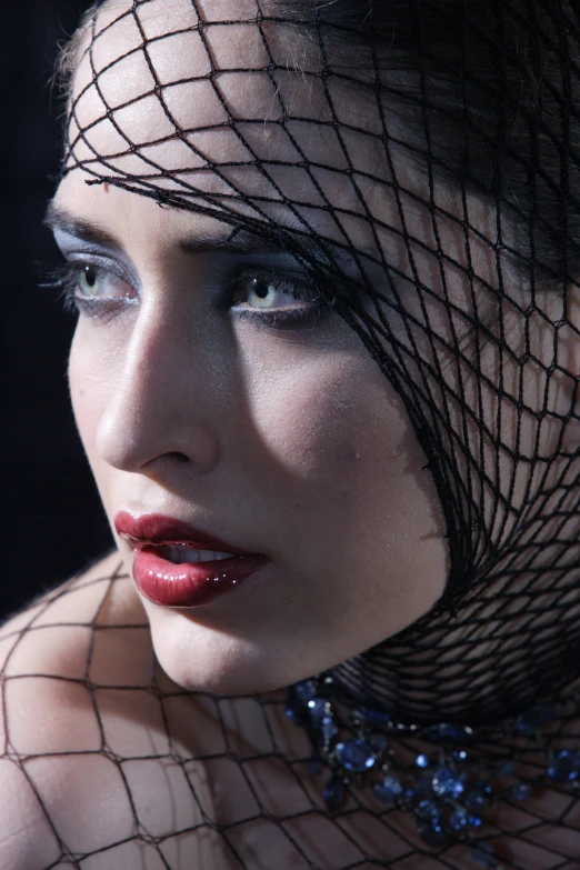 a beautiful young woman wearing a black veil over her head