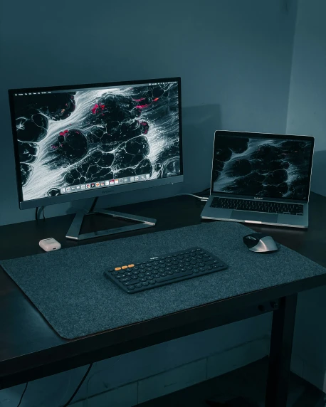 a two monitor desk with keyboard and mouse