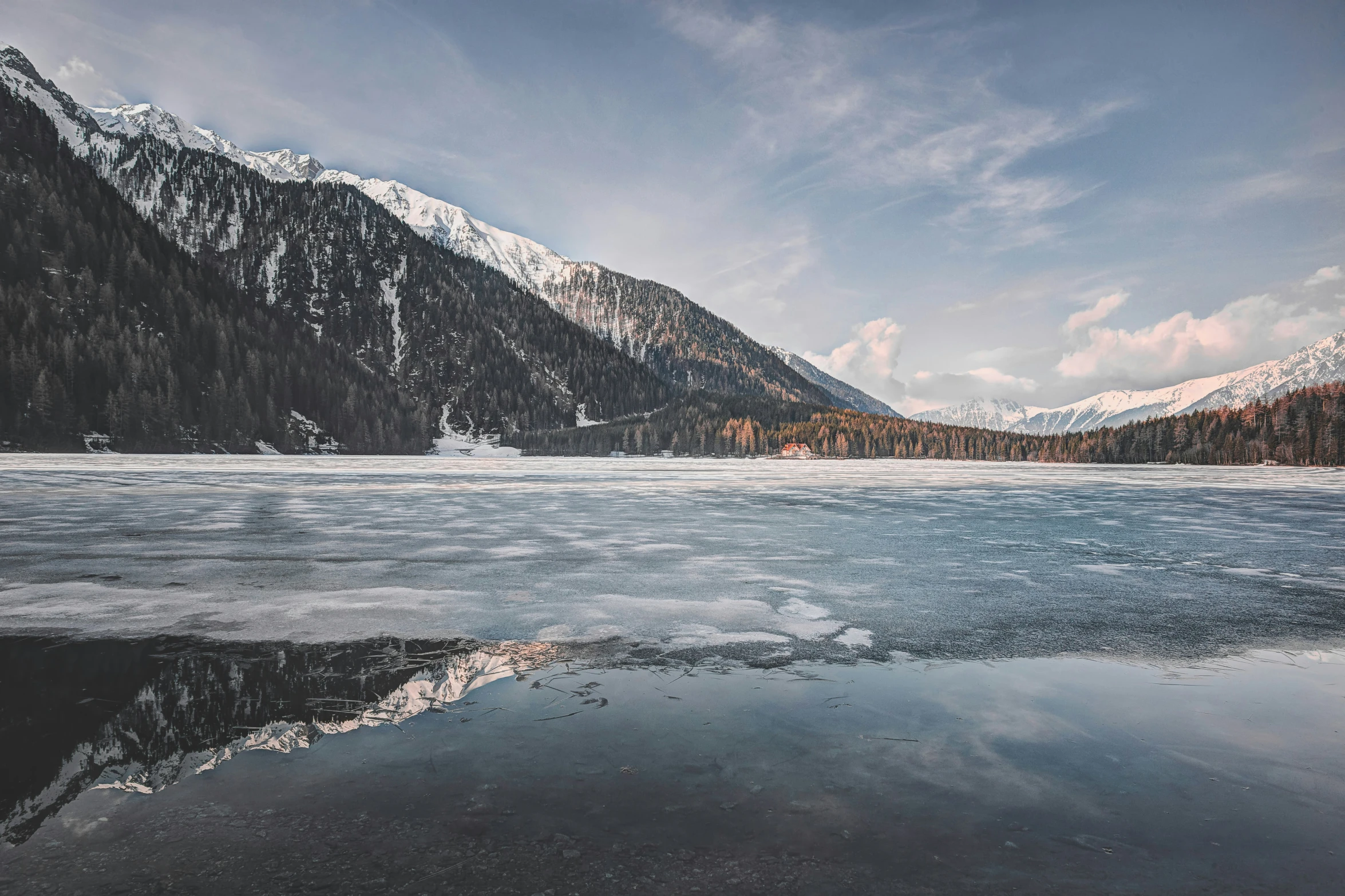 a large lake is in front of a mountain