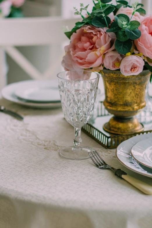 pink flowers sit on a table at a wedding reception