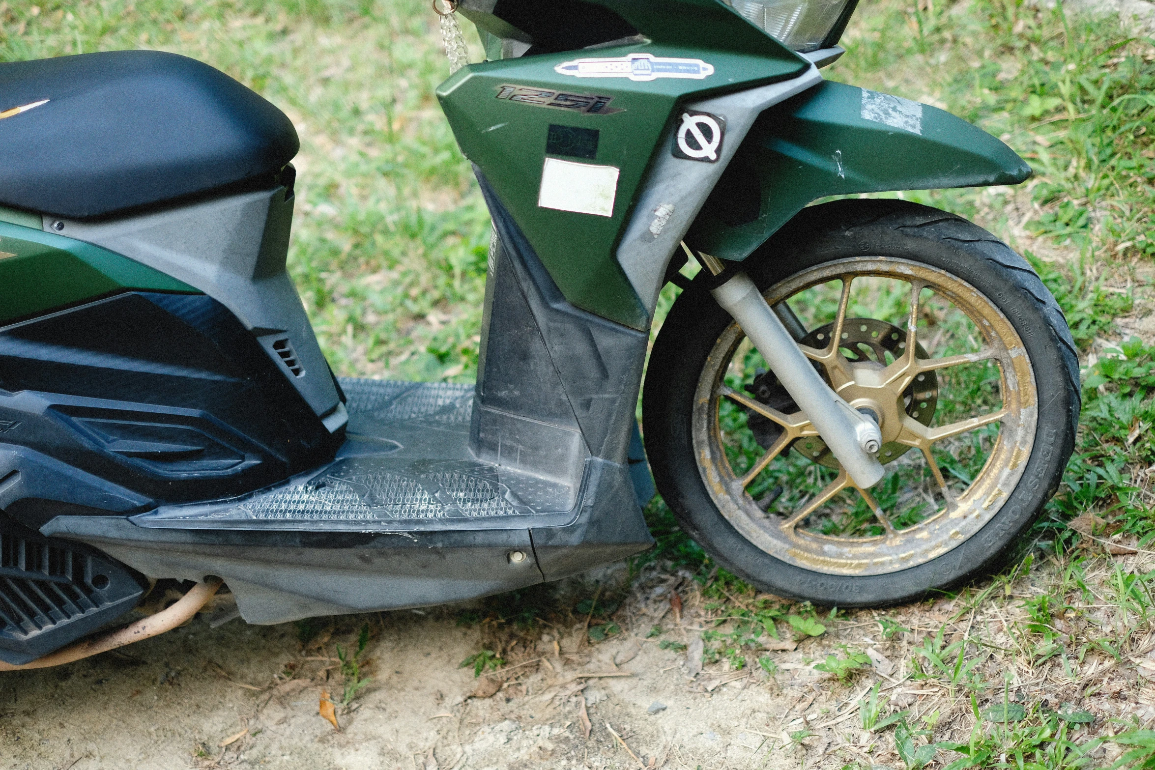 a motor scooter parked in the grass