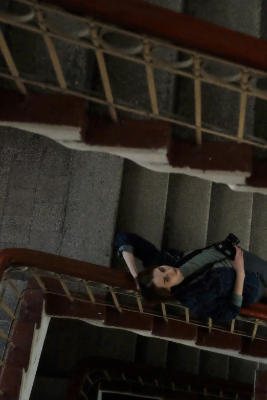 a woman laying down on a set of stairs