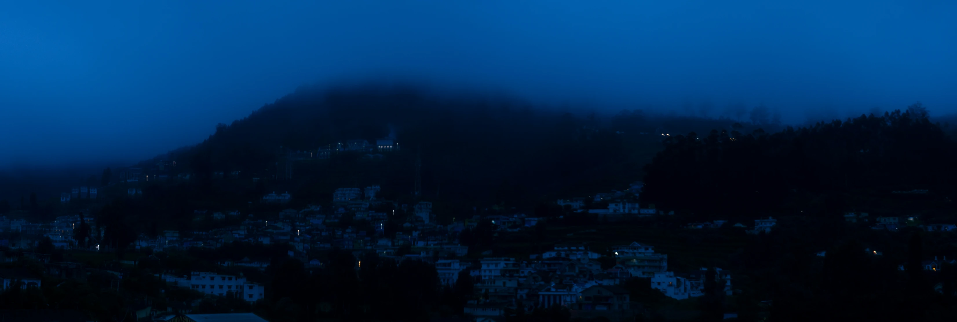 fog rising over a small town in the mountains