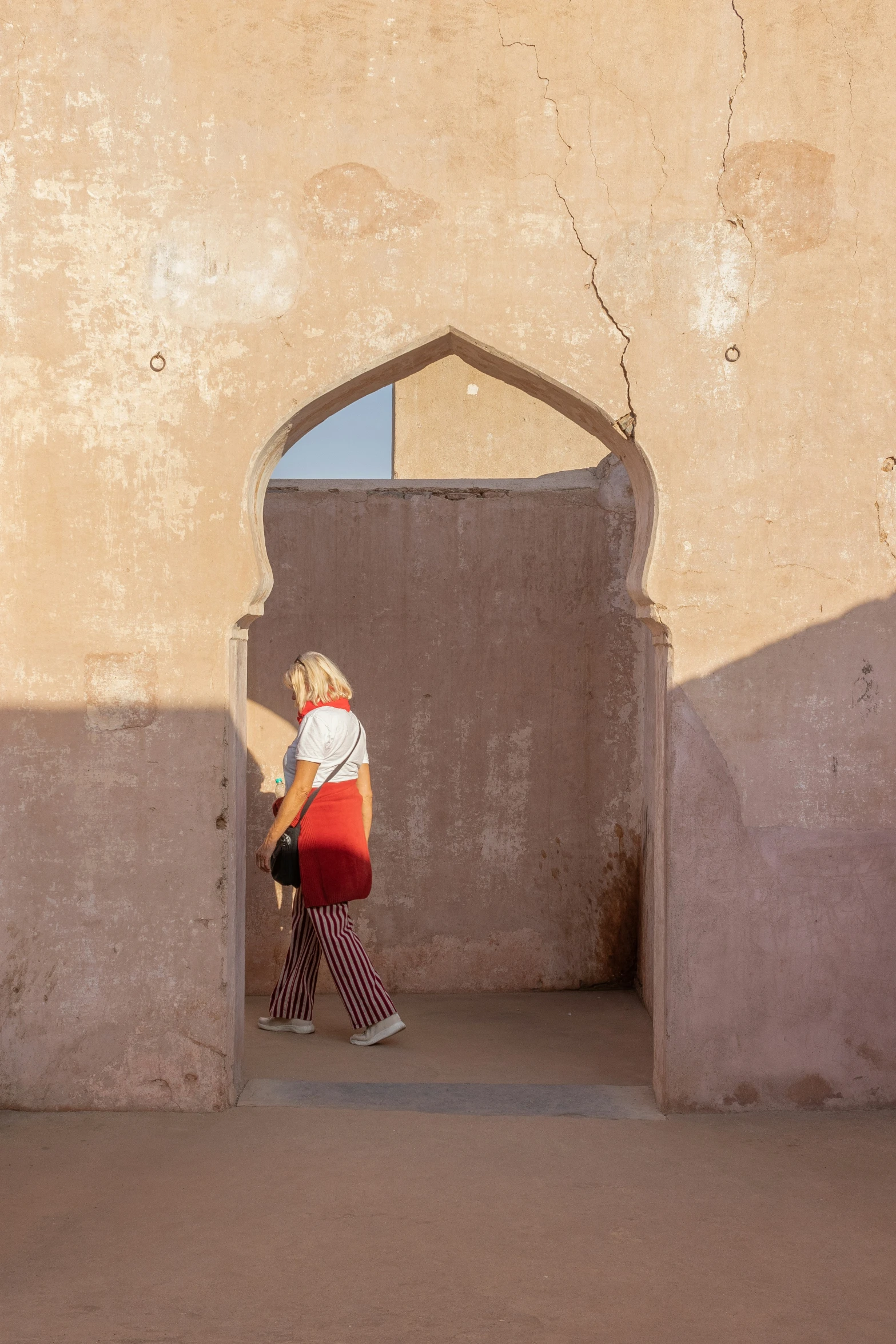 a woman walking towards an entrance into a building