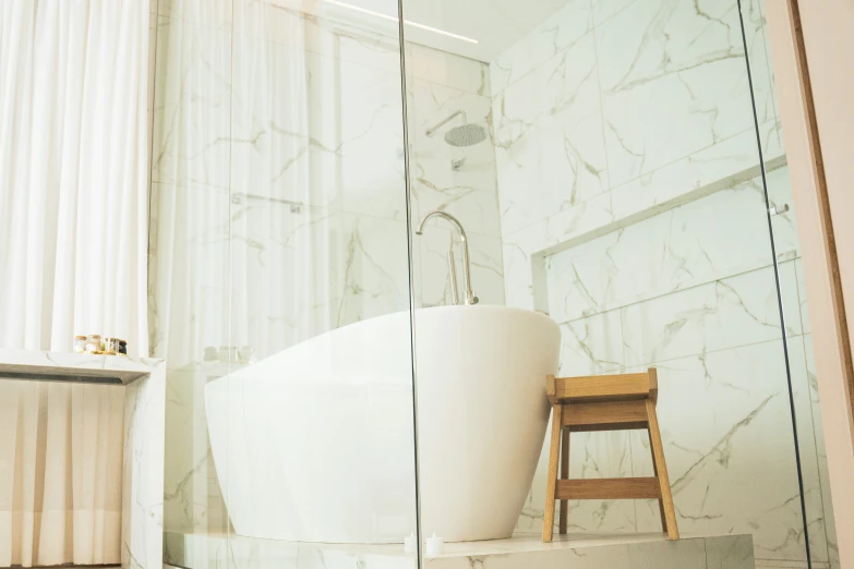 an old white tub and chair in a bathroom