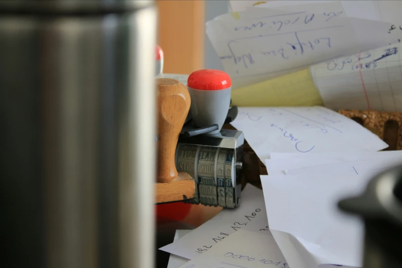 cluttered station with papers and rubber stamp