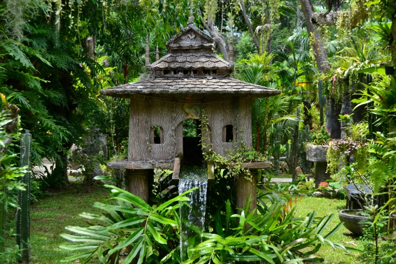 an elaborate garden with a small gazebo in the center