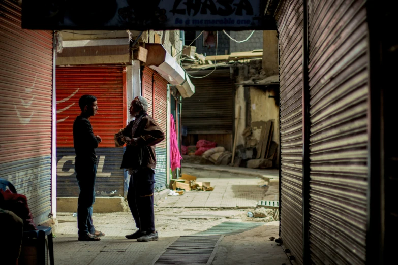 a couple of people are talking near a store