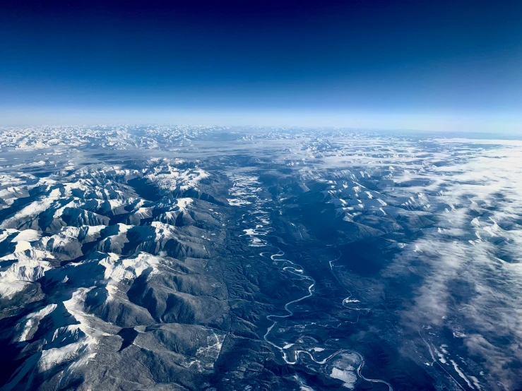 the view from an airplane of mountains and valleys