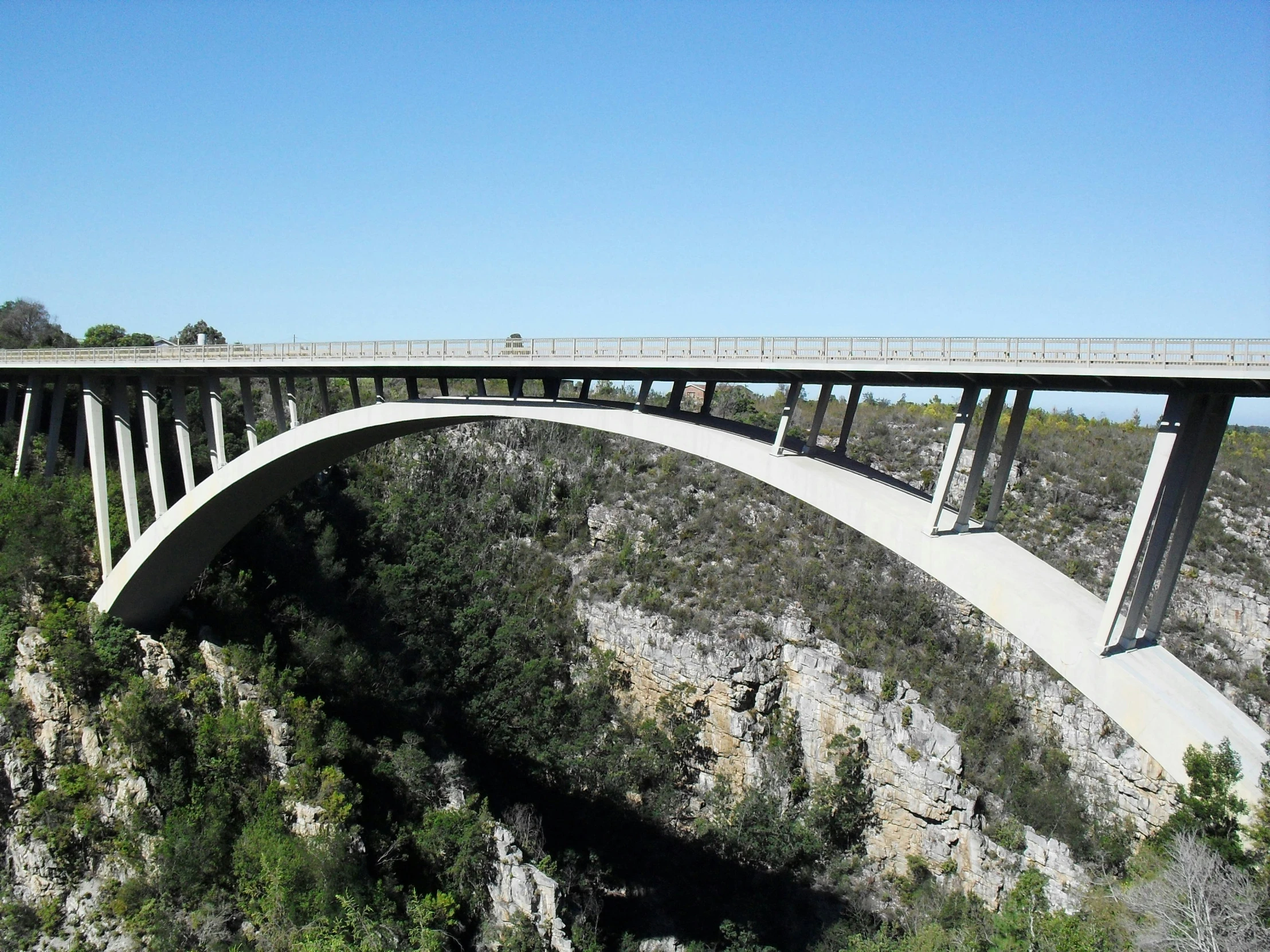 a view of the bridge from below and looking down at the road