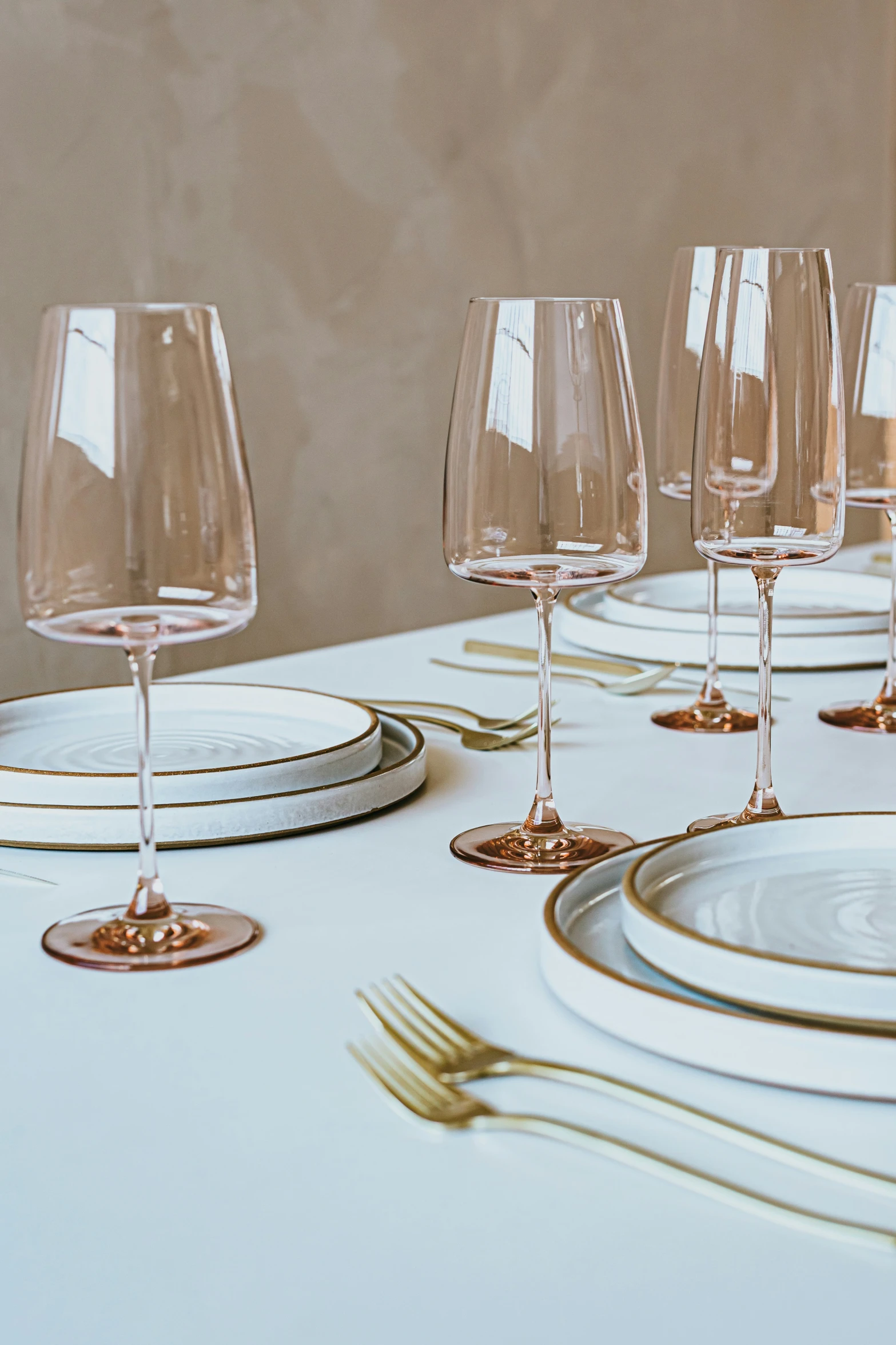 a table set with glasses and plates on it
