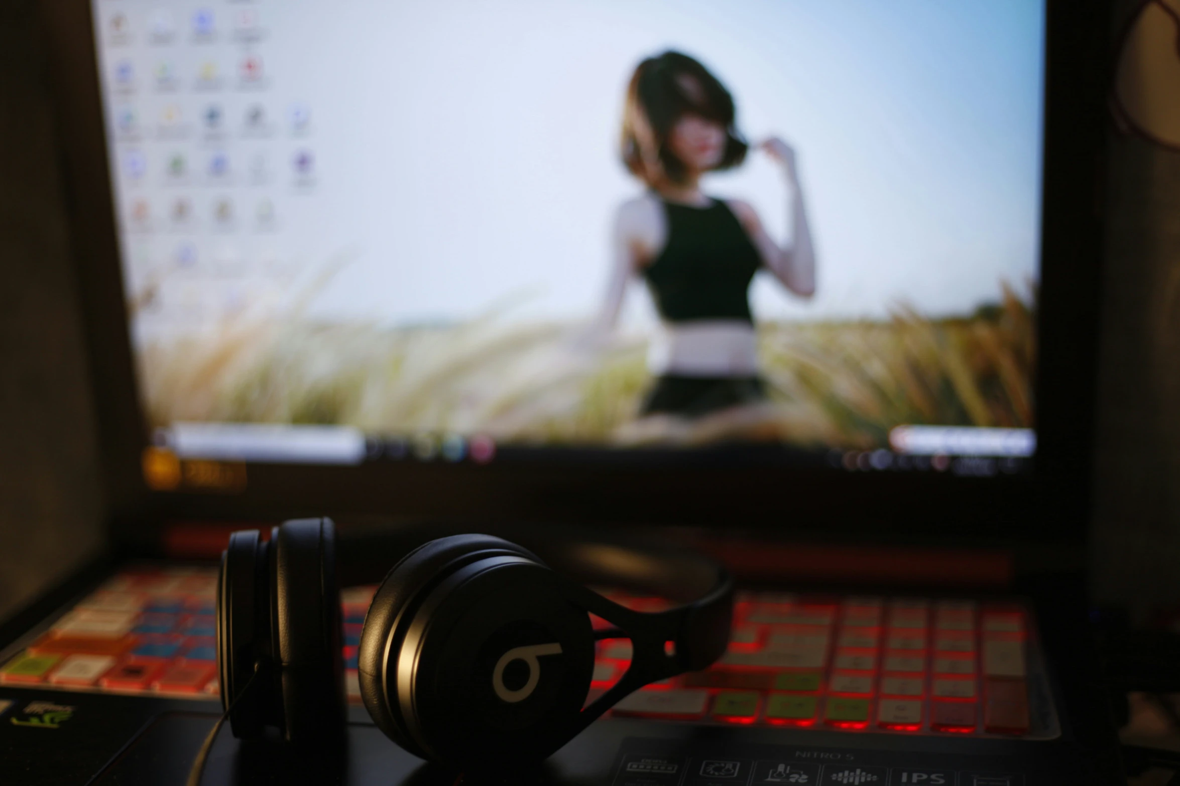 a pair of headphones sitting in front of a computer monitor