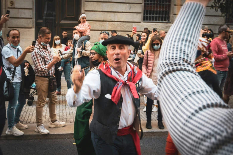 a man in costume, posing for a po with a crowd