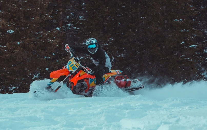 a person riding on a snowmobile in the snow
