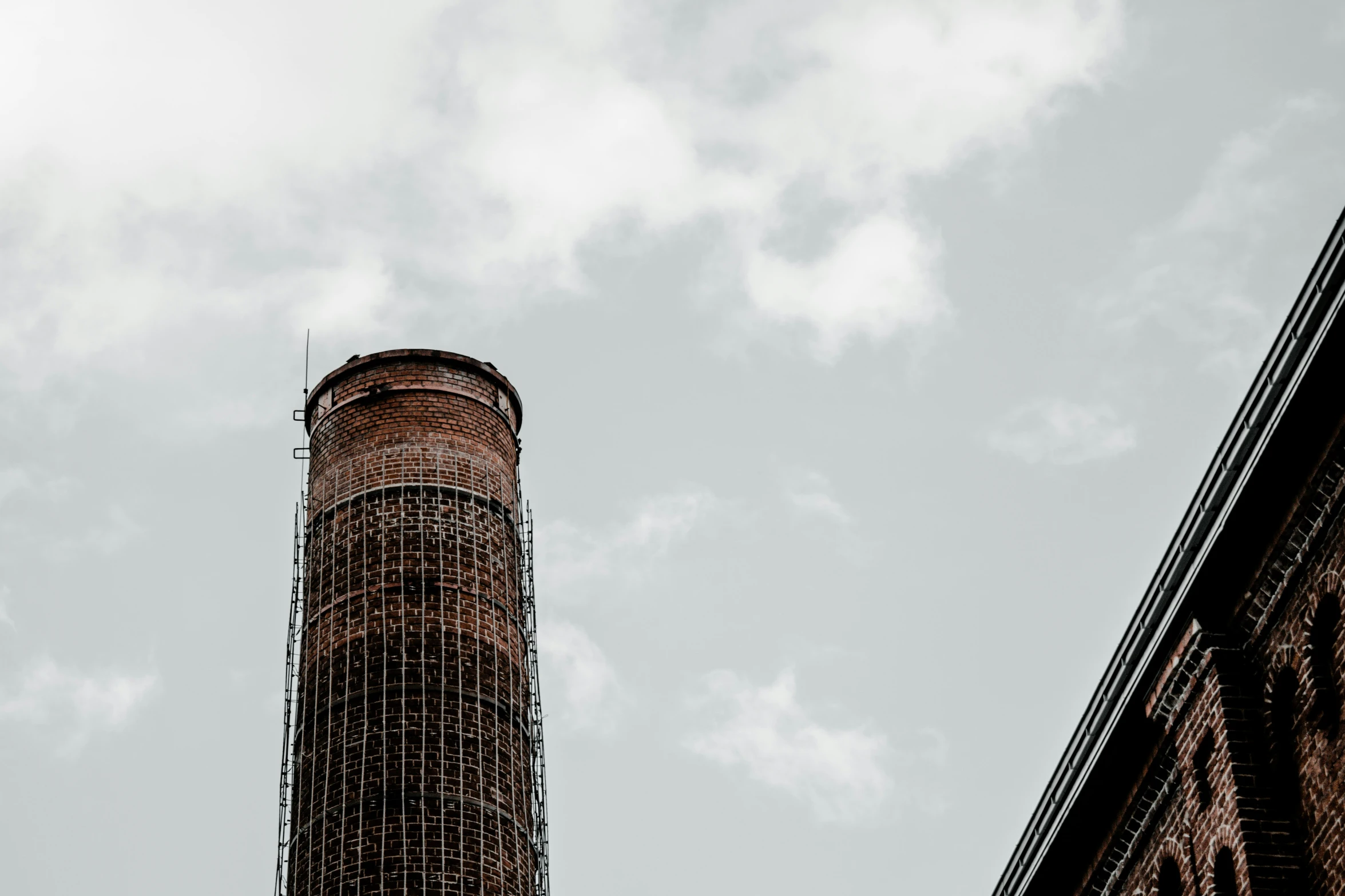 a tall tower with a clock is on a cloudy day