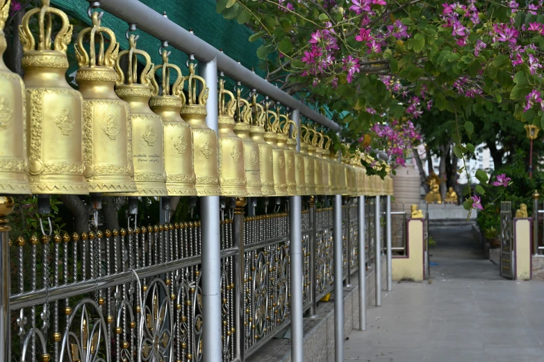 large gold bells are lined up in rows