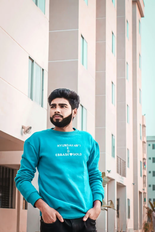 a man posing in front of two tall buildings