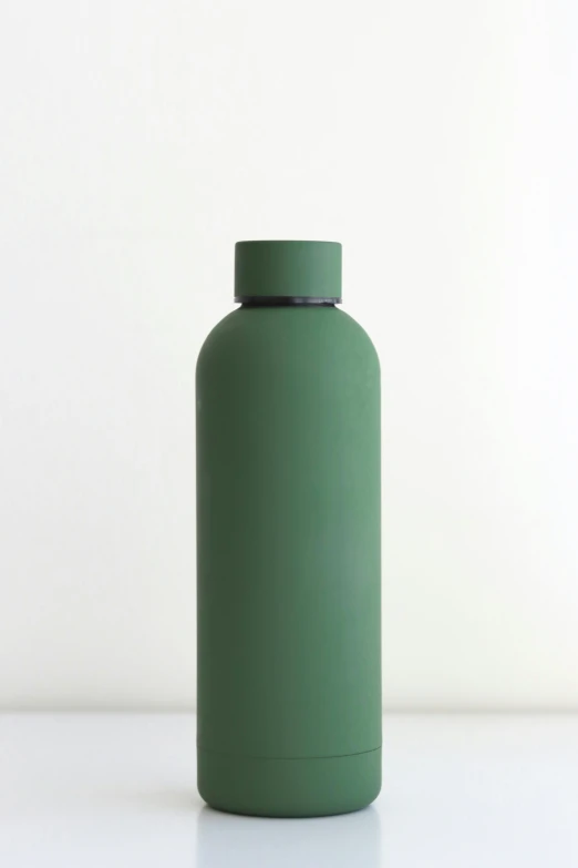 a plain green bottle sits on the floor