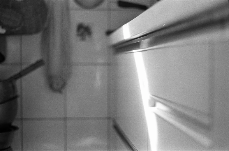 a woman looking down in the bathroom sink